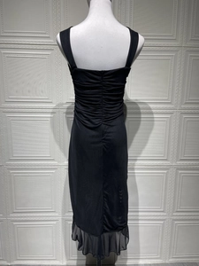 Detailed back view of black sleeveless bodycon dress with ruching and ruffle hem detail