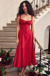 Close-up of red floral summer dress with corset waist and pleated neckline detail
