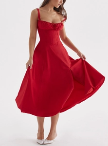 Detail of red floral corset midi dress featuring lace-up bodice and front slit