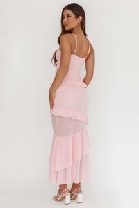 Detail view of pink layered ruffles and translucent tulle fabric on the backless maxi dress