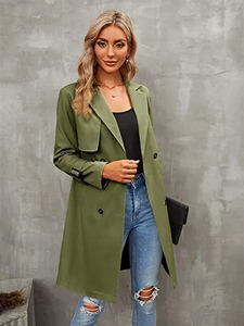 Detail of olive double-breasted trench coat featuring classic lapels and cuff buckle straps