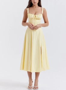 Detail of light yellow floral sundress featuring drawstring bust and high side slit
