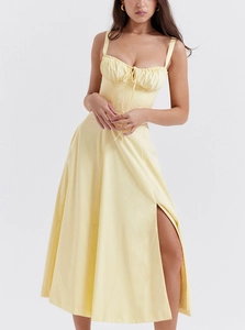 Detail of yellow floral summer dress featuring corset-style drawstring and high side slit
