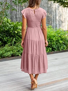 Detail of smocked back and ruffled cap sleeves on pink tiered midi summer dress