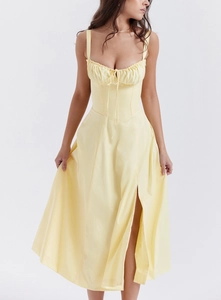 Detailed view of pale yellow floral corset dress featuring side slit and drawstring tie