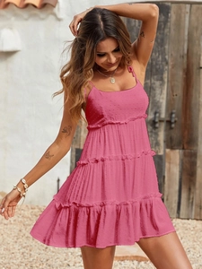 Close-up detail of hot pink Swiss dot fabric on a layered tiered summer mini dress