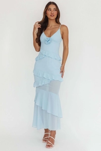 Detail of light blue dress with 3D flower, ruffle layers and sheer hemline