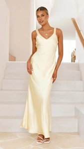 Detail of light yellow satin dress showing the V-neckline and smooth fabric texture