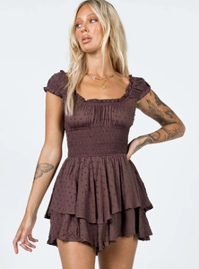 Detail of Swiss dot texture on a brown mini dress with smocked waist and ruffled hem