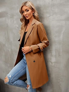 Detail of classic double-breasted trench coat with wide lapels and buttoned cuffs