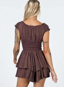 Detail of dark brown Swiss dot mini dress with smocked back and ruffled hemline
