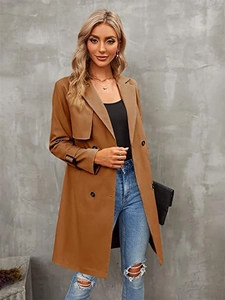 Detail view of classic double-breasted camel trench coat with notched lapels and cuff straps