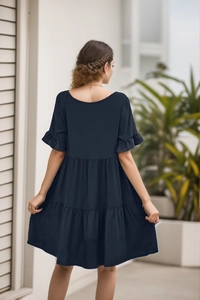 Rear view of navy blue V-neck babydoll dress with three-layer pleated cake skirt details