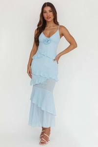 Detail of light blue chiffon dress featuring a 3D floral accent and ruffled layers