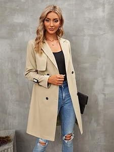 Detail of classic double-breasted trench coat with adjustable cuffs and black buttons