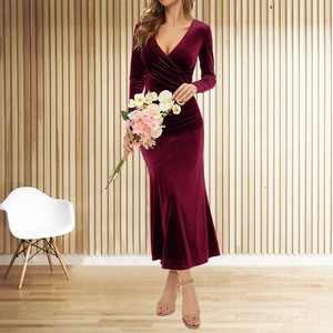 Detail of burgundy velvet V-neck dress with ruched waist and elegant fish tail silhouette