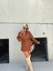 Detail of rust brown long sleeve shirt bodysuit with drawstring waist and button closure