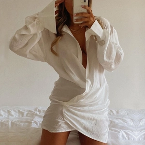 White deep V-neck long sleeve shirt dress with twist front detail and irregular hem