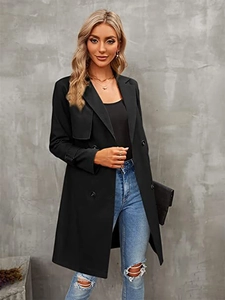 Detail of a women's double-breasted black trench coat with classic lapels and cuff straps