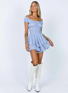 Close-up of light blue off-shoulder dress with elastic waist and tiered ruffle hemline