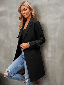 Detail of classic double-breasted black trench coat with lapel collar and cuff straps