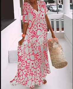 Detail of V-neck floral maxi dress with bohemian pink print and flowing tiered skirt