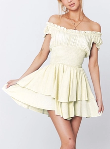 Detail of light yellow smocked dress with off-shoulder ruffles and layered hem