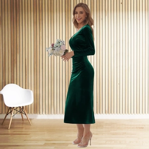 Detailed texture of dark green velvet dress with V-neck and elegant waist ruching