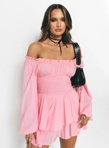 Detail of pink off-shoulder dress with elastic smocking waist and flared long sleeves