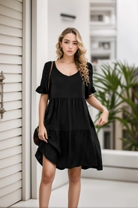 Detail of V-neckline and tiered ruffle layers on a casual black summer dress
