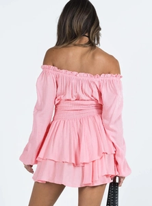 Detail view of pink off-shoulder dress featuring elastic waist and layered ruffle hemline