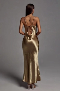 Close-up of champagne gold satin dress featuring an elegant backless design and bow detail