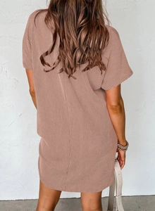 Rear view of mauve ribbed knit short sleeve dress showing draped fit and vertical texture