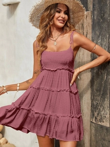Detail of dusty rose tiered dress showing intricate textured polka dot fabric