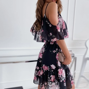 Close-up of floral chiffon dress with cold-shoulder cut and ruffled hem details