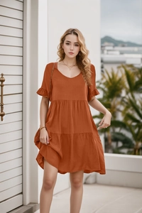 Detail of V-neckline and tiered ruffle layers on summer rust-colored babydoll dress