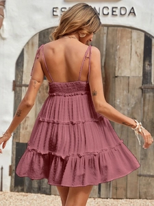 Detail of pink backless sundress with smocked back and tiered dot texture fabric