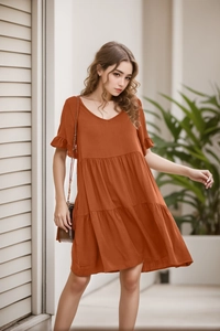Detail of V-neckline and ruffled sleeves on this orange tiered casual summer dress