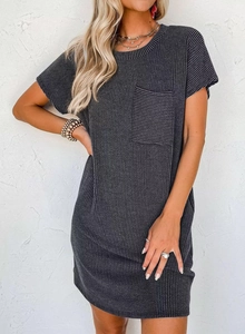 Detail of charcoal grey ribbed knit dress featuring a functional front chest pocket