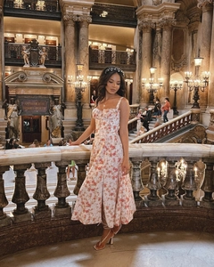 Close-up of floral slip dress featuring a high slit and drawstrings in an elegant hall