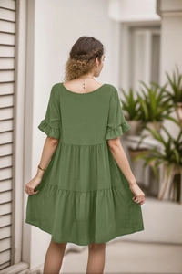 Detail view of sage green tiered dress featuring ruffle sleeves and open back design