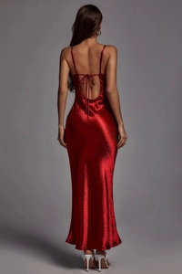 Detail of red satin backless maxi dress featuring thin straps and an elegant bow tie