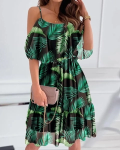 Detail of tropical palm leaf print and ruffle cold-shoulder design on summer chiffon dress