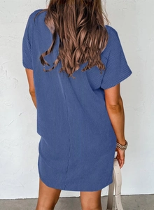 Back view of a blue short sleeve ribbed knit dress featuring a subtle textured pattern
