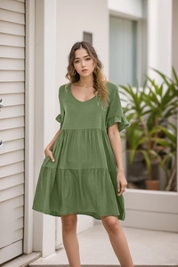 Detail view of V-neck tiered olive green summer dress with ruffle sleeves and pleated hem