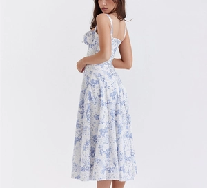 Detail view of the back tie-up design on a blue floral midi dress with a high side slit