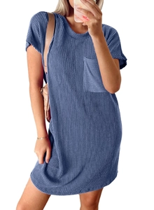 Detail of blue waffle knit dress showing texture, round neck and chest pocket