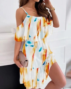 Detail of white off-shoulder chiffon dress with bright orange and yellow brushstroke prints
