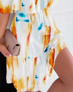 Detail of floral chiffon dress showing tiered ruffle hem and vibrant watercolor print