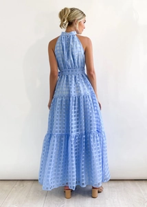 Detailed back view of a light blue halter dress with tiered skirt and matching belt